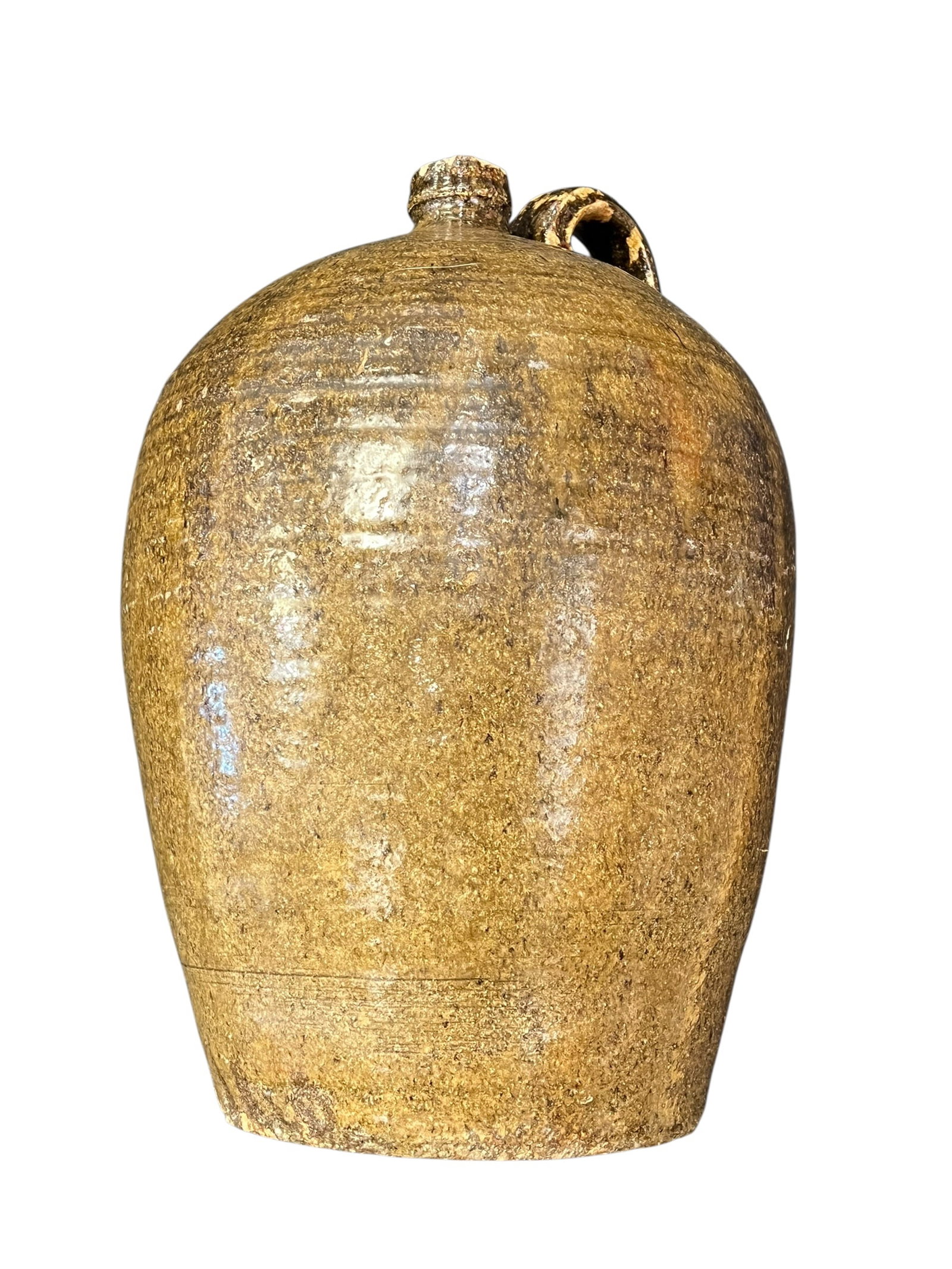 Antique Southern Stoneware Jug with Loop Handle – Brown Alkaline/Slip Glaze: Antique Southern utilitarian stoneware jug of large ovoid form with rounded shoulders, small cylindrical mouth, and applied loop handle. The vessel displays a rich, variegated brown glaze ranging from