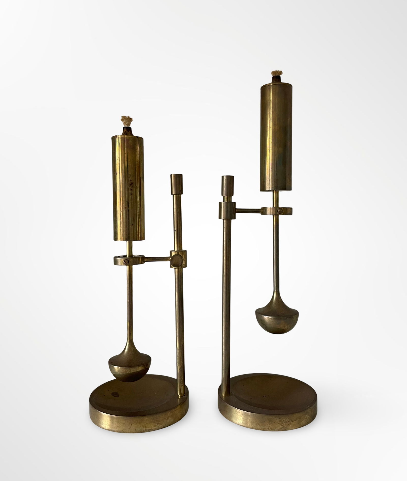 Pair of Brass Oil Lamps by Ilse D. Ammonsen, c. 1970s: Pair of brass oil lamps used for ships, which swings to keep them level, height is adjustable at the stem. Each one is stamped on the base. Runs on normal lamp oil.
