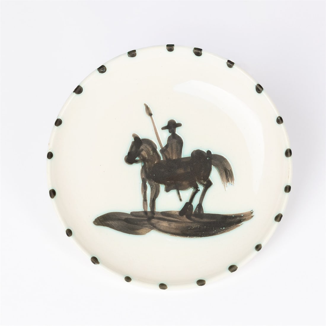Pablo Picasso. ”Picador”. 1952: Pablo Picasso (Málaga 1881 – 1973 Mougins). ”Picador”. 1952 White clay with paraffin- and enamel paint. Diameter: 20,5 cm (8 ⅛ in.). On the underside