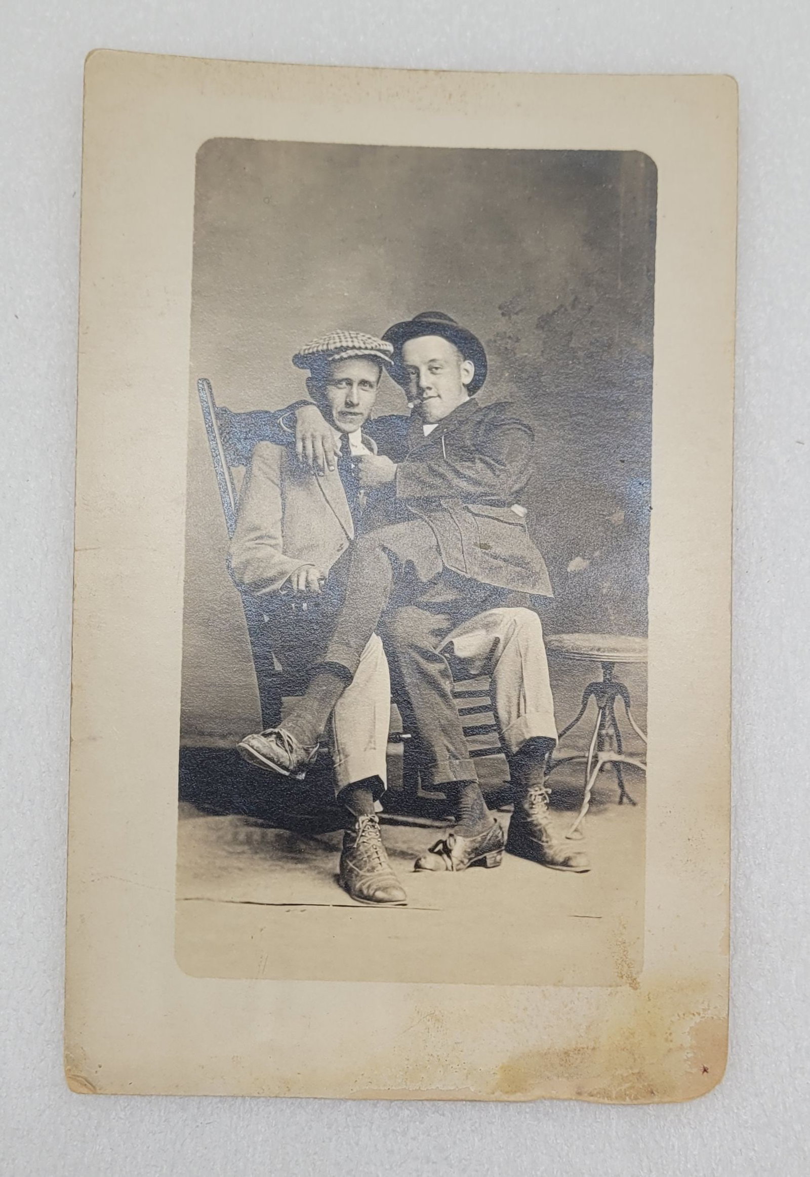 RPPC of Two Men In A Rocking Chair Artura Backstamp: RPPC of Two Men In A Rocking Chair Artura Backstamp - 3 3/8" by 5 3/8".