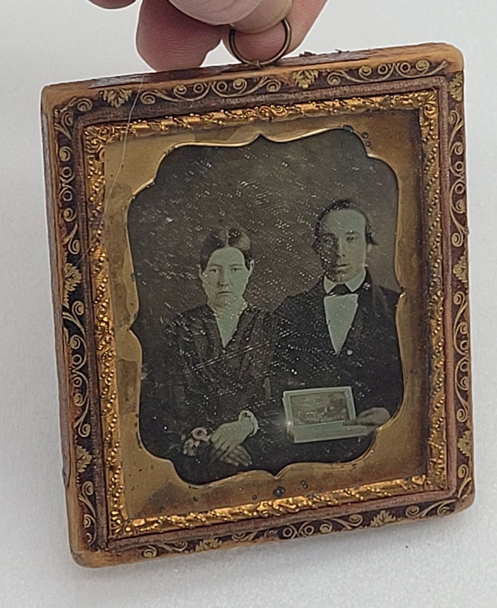 Daguerreotype of Woman & Man Holding Book: Daguerreotype of Woman & Man Holding Book - 3.25" by 3.75".