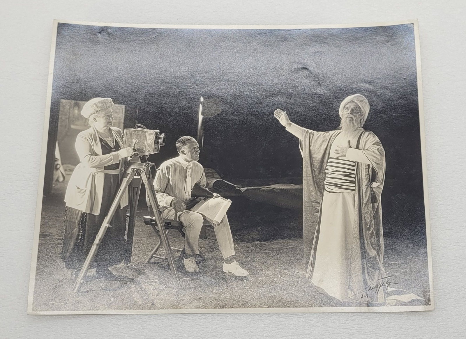 Photograph of Frederick Warde Cast as Omar w Ferdinand Earle & Mrs. Warde Turning The Crank: Photograph of Frederick Warde Cast as Omar w Ferdinand Earle & Mrs. Warde Turning The Crank - 7.5" by 9.5".
