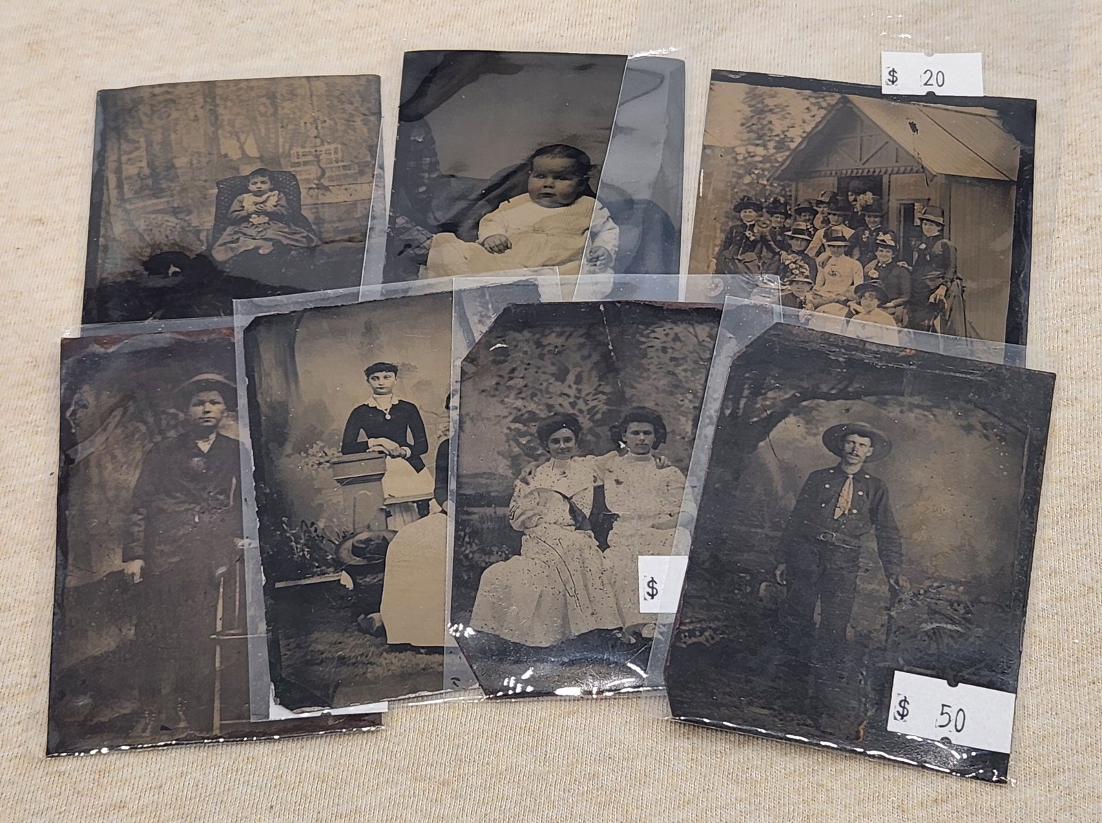 Antique Tintype Photographs - Collection of 7 Vintage Photos: This lot features a collection of 7 antique tintype photographs. The collection showcases images of women, men, children, and groups in various settings. All of the tintypes are individually priced. A