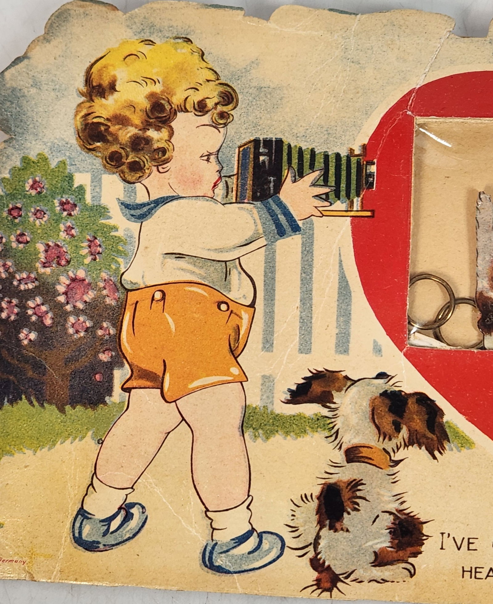 Antique Valentine's Day Card - Boy, Dog, & Cat - 3D Heart: This is an antique Valentine's Day card that is about 12 inches wide and 6 inches tall. It features a young boy with a camera, a boy holding a basket of hearts, a dog, and a cat. There is a red heart