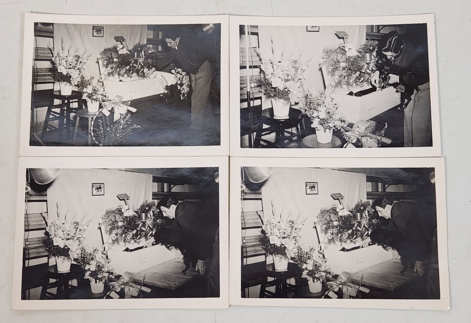 Vintage Funeral Scene Photographs - Lot of 4: This is a lot of 4 vintage photographs depicting a funeral scene. The photographs, printed in black and white, capture moments around a casket adorned with floral arrangements. Each photo shows a simi