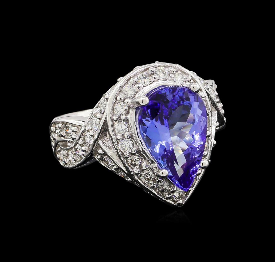 14KT White Gold 3.10 ctw Tanzanite and Diamond Ring: One electronically tested 14KT white gold ladies cast tanzanite and diamond ring with a bright polish finish. Identified with markings of "K14". Condition is new. Containing: One prong set oval modifi