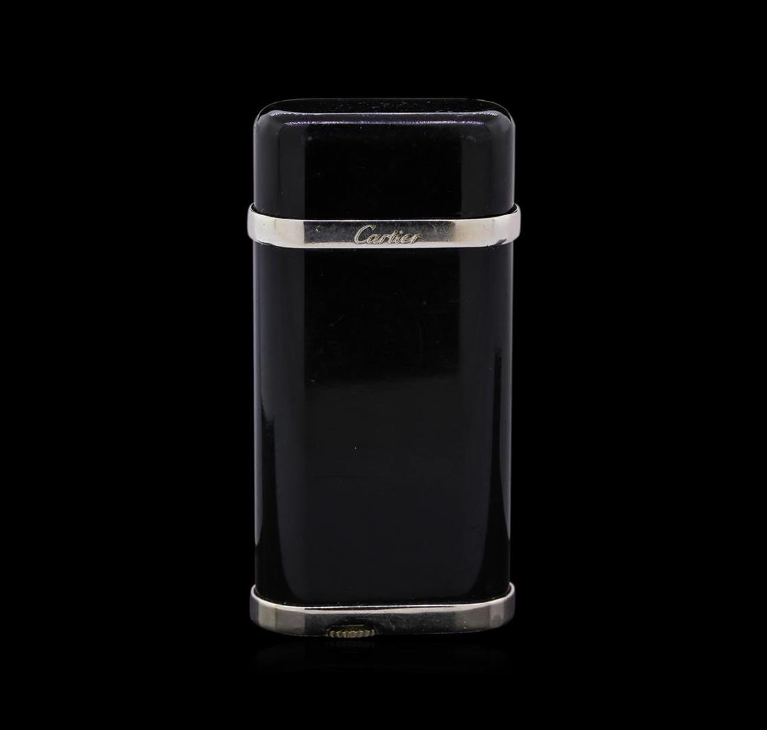 Cartier Black Composite Lighter: One Cartier lighter featuring: Black composite body, black cap, and palladium finish detail. Stamped Cartier and SWISS MADE. Dimensions: Height 60 mm x Width 29 mm.