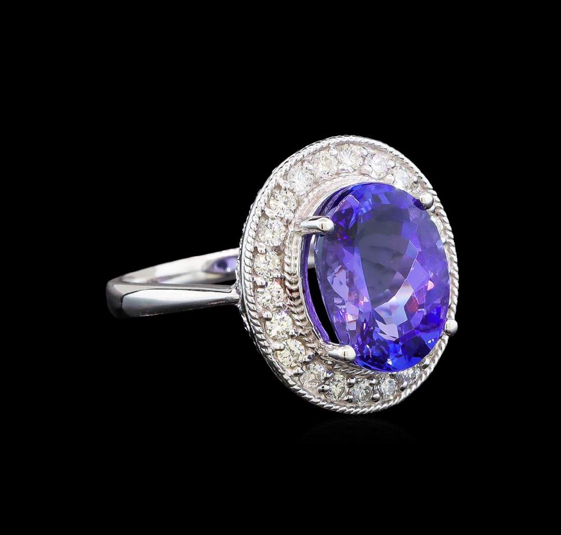 14KT White Gold 5.61 ctw Tanzanite and Diamond Ring: One electronically tested 14KT white gold ladies cast tanzanite and diamond ring with a bright polish finish. Identified with markings of "14K". Condition is new. Containing: One prong set oval modifi