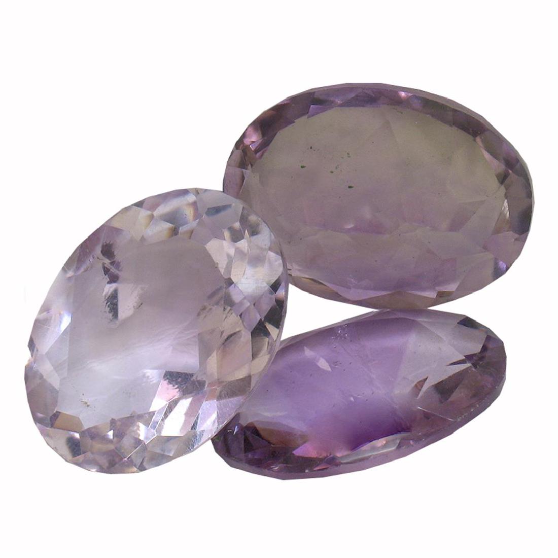 22.03 ctw Oval Mixed Amethyst Parcel: Three oval mixed cut natural amethysts exact total weight 22.03ct., clarity is slightly included, type II, medium dark, very slightly grayish, purple color, (GIA P 6/3), cut is good. Westfield Apprais