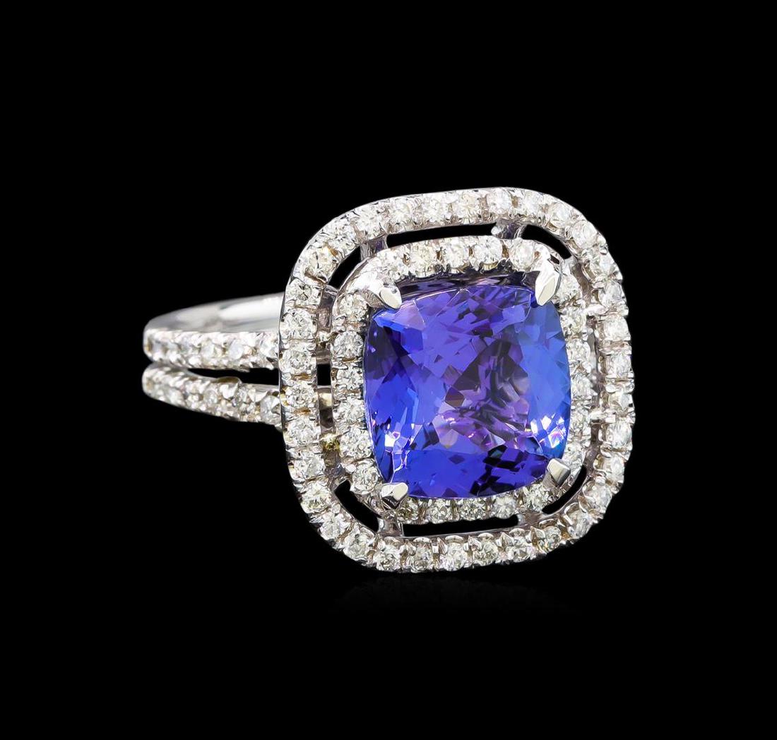 14KT White Gold 3.98 ctw Tanzanite and Diamond Ring: One electronically tested 14KT white gold ladies cast tanzanite and diamond ring with a bright polish finish. Identified with markings of "K14". Condition is new. Containing: One prong set square cush