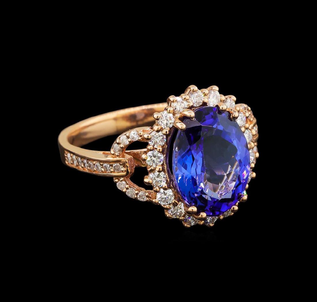 14KT Rose Gold 4.13 ctw Tanzanite and Diamond Ring: One electronically tested 14KT rose gold ladies cast tanzanite and diamond ring with a bright polish finish. Identified with markings of "K14". Condition is new. Containing: One prong set oval modifie