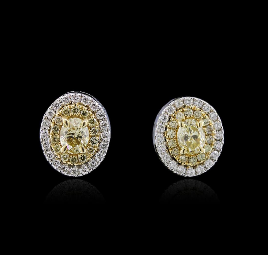 1.45 ctw Fancy Yellow Diamond Earrings - 14KT White and: One pair electronically tested 14KT white and yellow gold ladies cast diamond earrings with friction posts with a bright polish finish. Identified with markings of "14K". Condition is new. Containing: