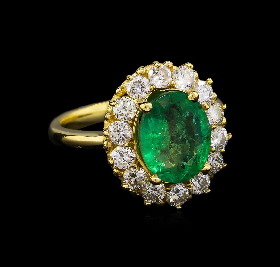 14KT Yellow Gold 2.69 ctw Emerald and Diamond Ring: One electronically tested 14KT yellow gold ladies cast emerald and diamond ring with a bright polish finish. Condition is new, good workmanship. The featured emerald is set within a diamond bezel supp