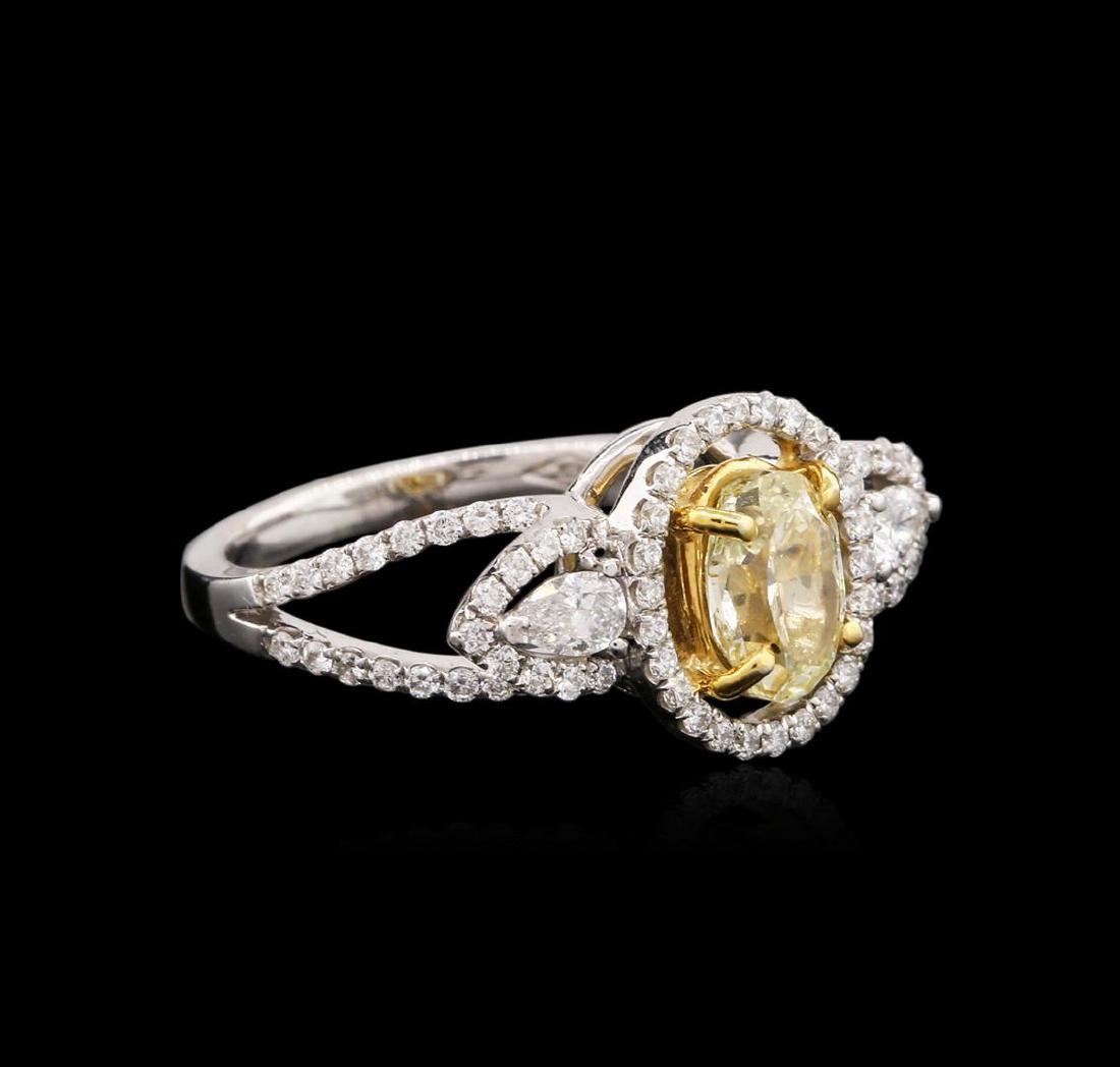 18KT Two-Tone Gold 1.22 ctw Fancy Yellow Diamond Ring: One electronically tested 18KT white and yellow gold ladies cast diamond engagement ring with a bright polish finish. Identified with markings of "18K". Condition is new. Containing: One bezel set ova