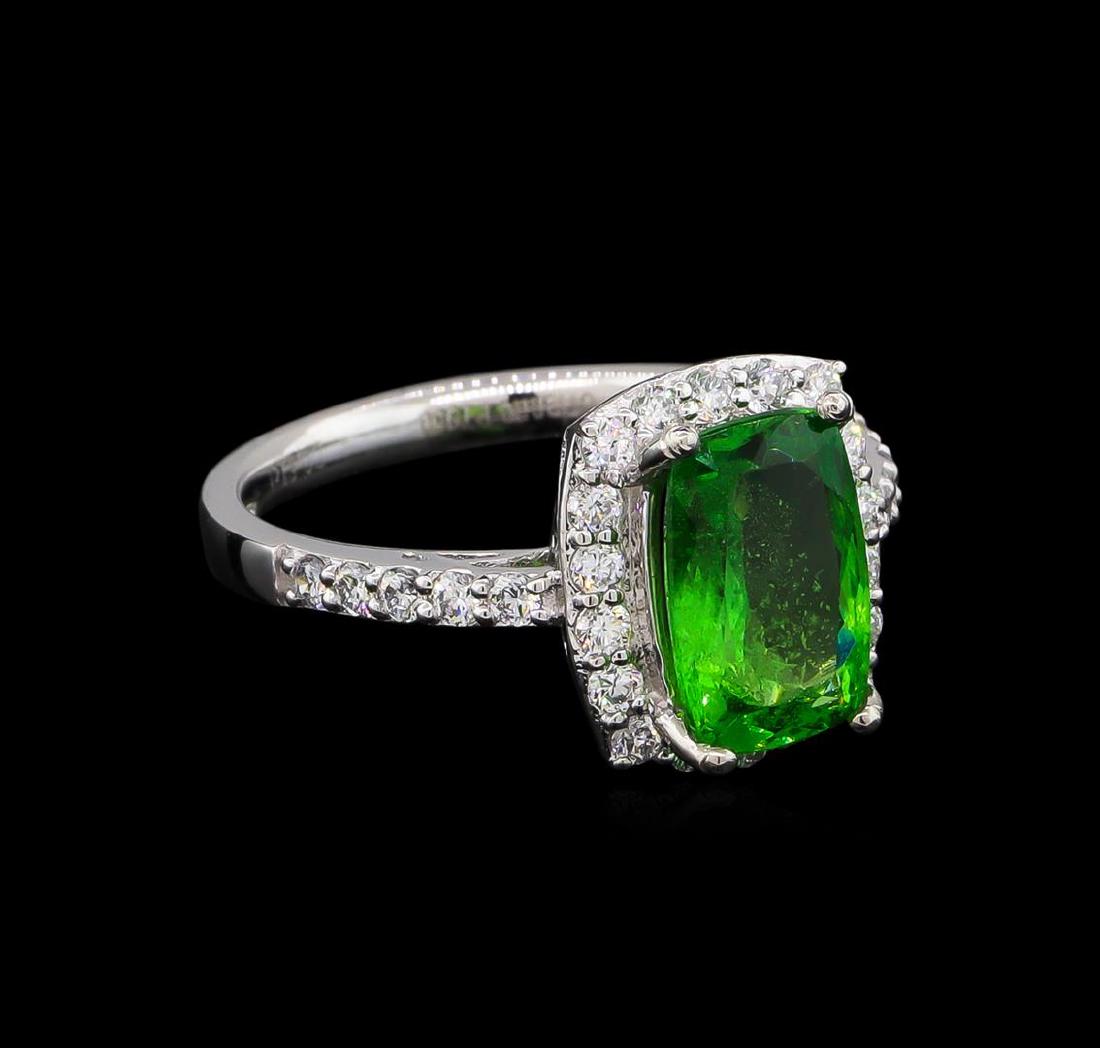 2.30 ctw Tsavorite and Diamond Ring - Platinum: One electronically tested platinum lady's cast fashion ring with a cathedral shank with a halo with a bright polish finish. The featured lady's ring has a shank measuring 2.30 millimeters wide. Tradem