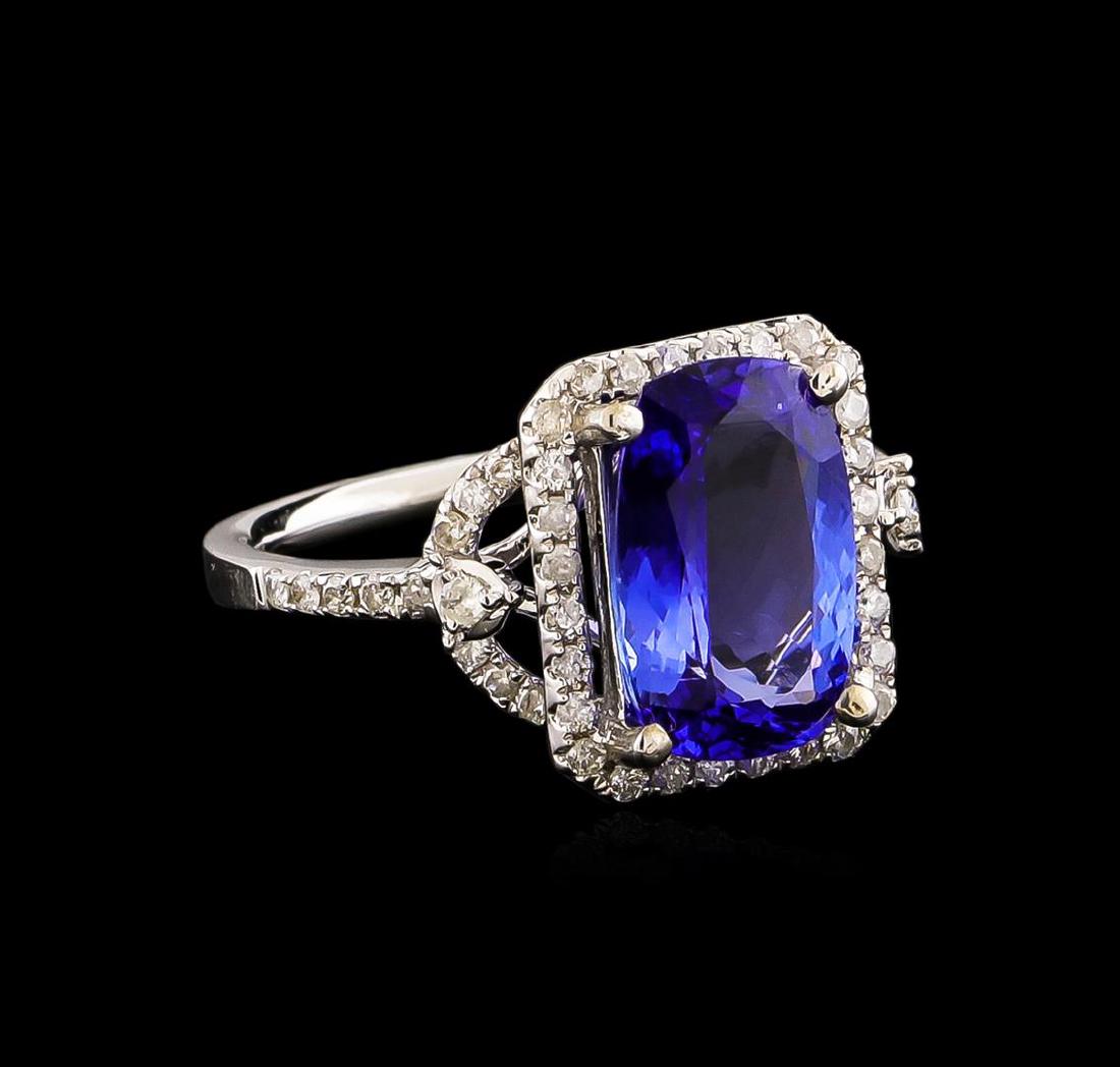 14KT White Gold 3.34 ctw Tanzanite and Diamond Ring: One electronically tested 14KT white gold ladies combination cast & assembled ring with a bright polish finish. Condition is new. Identified with markings of "14K". Containing: One prong set rectangul