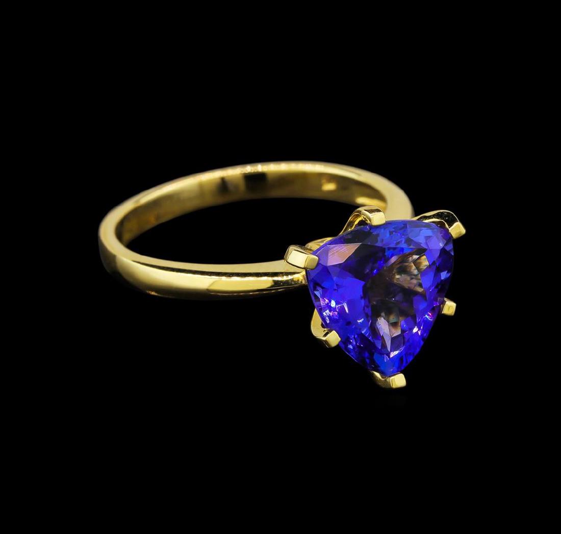 18KT Yellow Gold 4.82 ctw Tanzanite Ring: One electronically tested 18KT yellow gold ladies cast tanzanite ring with a bright polish finish. Identified with markings of "18K". Condition is new. Containing: One prong set triangle modified bril