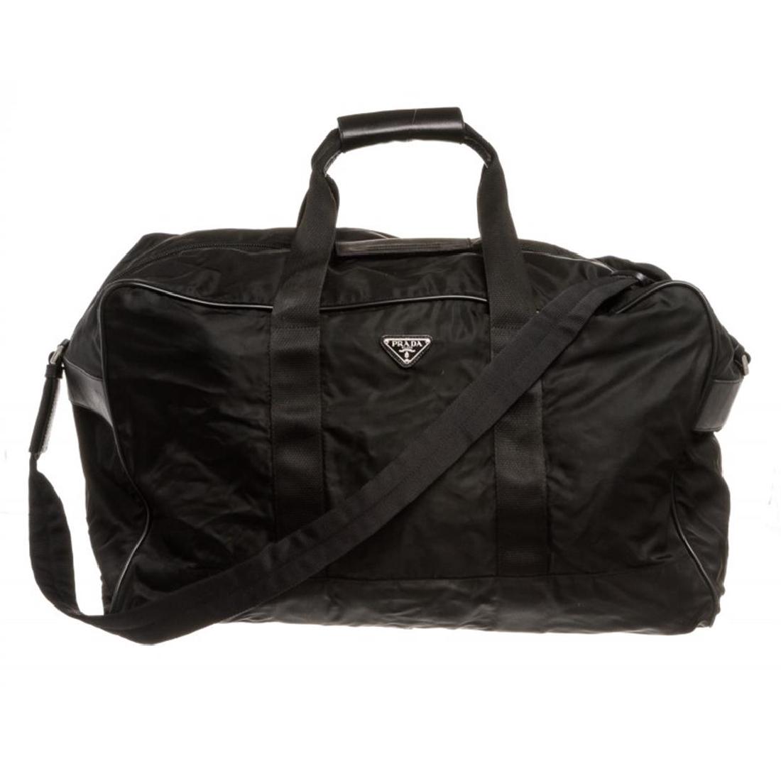 Prada Black Nylon Leather Double Handle Duffle Travel: Overall zipper closure with velcro flap. Interior is fabric lined, large interior with one large side zipper pocket. Dual handles with leather velcro grips, adjustable shoulder strap and Lock and Key