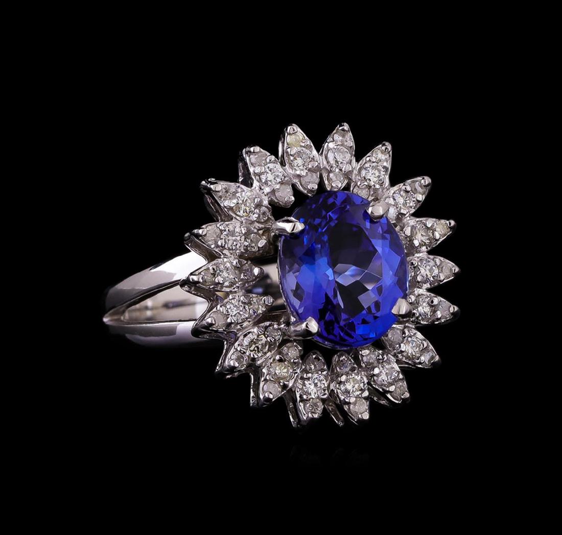 14KT White Gold 2.95 ctw Tanzanite and Diamond Ring: One electronically tested 14KT white gold ladies cast tanzanite and diamond ring with a bright polish finish. Identified with markings of "K14". Condition is new. Containing: One prong set oval modifi