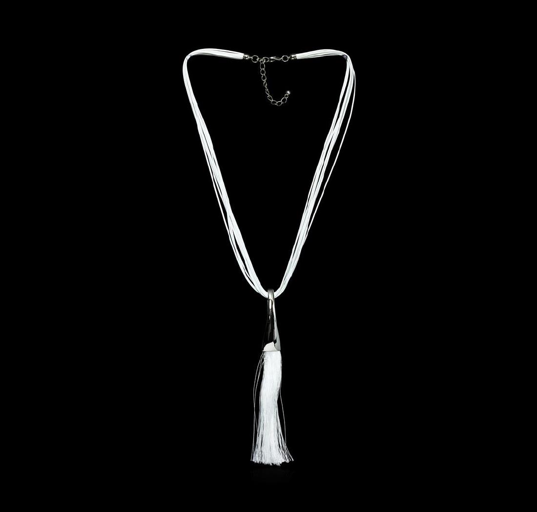 Silk Tassel Leather Necklace - Rhodium Plated: High end designer jewelry. Silk Tassel Leather Necklace - Rhodium Plated. Rhodium Plated Metal/3" Ext Clasp. White/ Silver. 28/7.5inches. Total Weight: 55 grams.