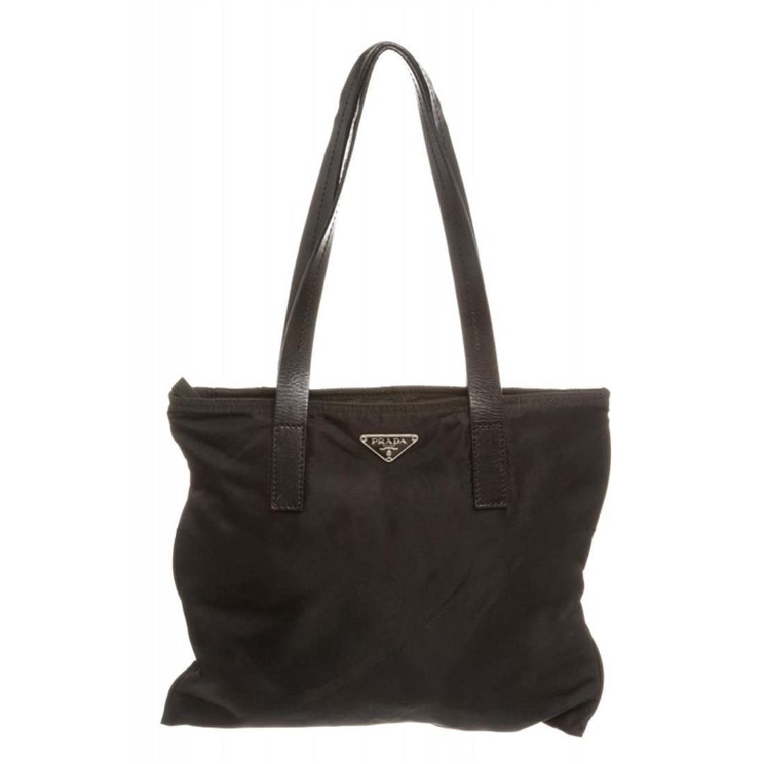 Prada Black Nylon Flat Shoulder Bag: Overall zipper closure. Interior is fabric lined and contains side zipper pocket.