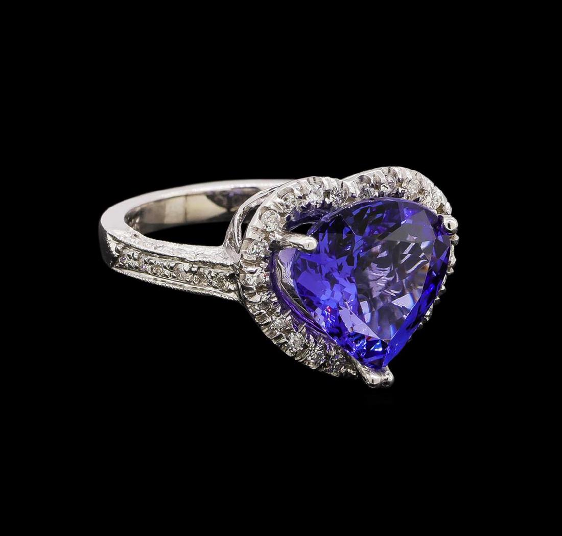 14KT White Gold 5.91 ctw Tanzanite and Diamond Ring: One electronically tested 14KT white gold ladies cast tanzanite and diamond ring with a bright polish finish. Identified with markings of "14K". Condition is new. Containing: One prong set heart modif