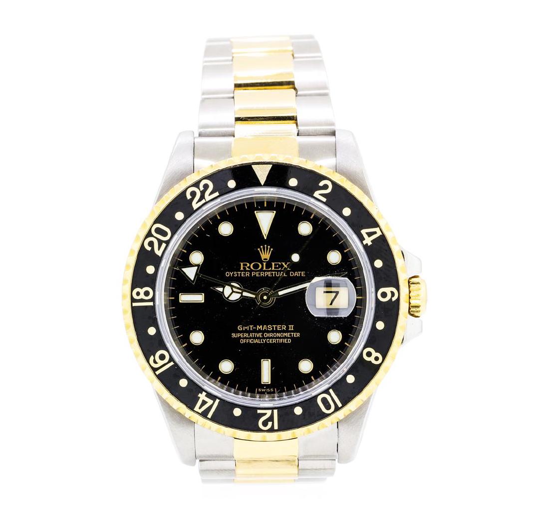 Rolex 18KT Yellow Gold and Stainless Steel Men's GMT: One 18KT yellow gold and stainless steel Rolex men's GMT Master II Oyster Perpetual wristwatch with a case measuring 40mm. The watch features a bidirectional rotating bezel with gold Arabic numerals, 