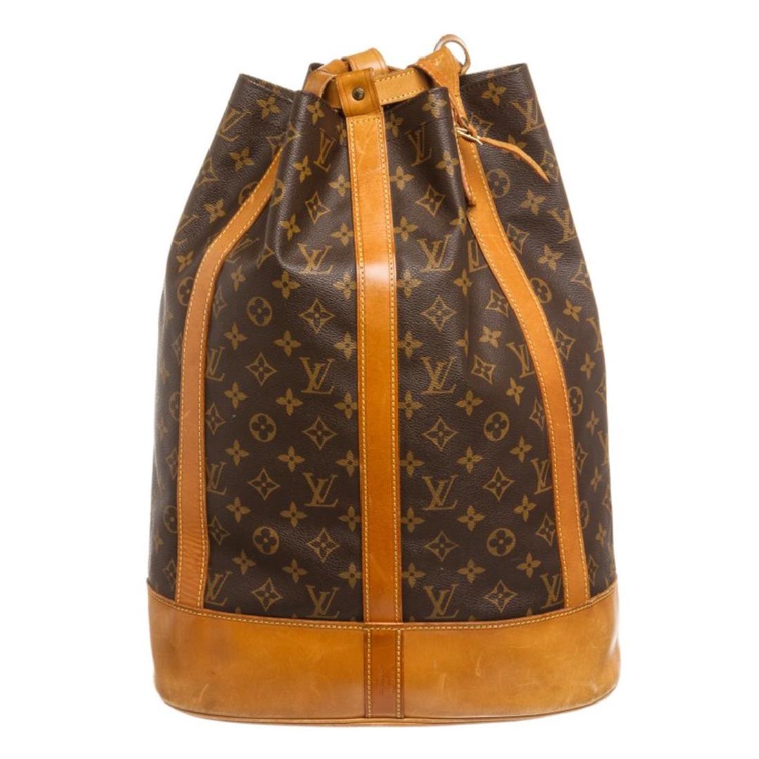 Louis Vuitton Monogram Canvas Leather Randonne Backpack: Brown and tan monogram coated canvas Louis Vuitton Randonne backpack with brass hardware, tan vachetta leather trim featuring yellow contrast stitching, dual flat shoulder straps, brown woven interior