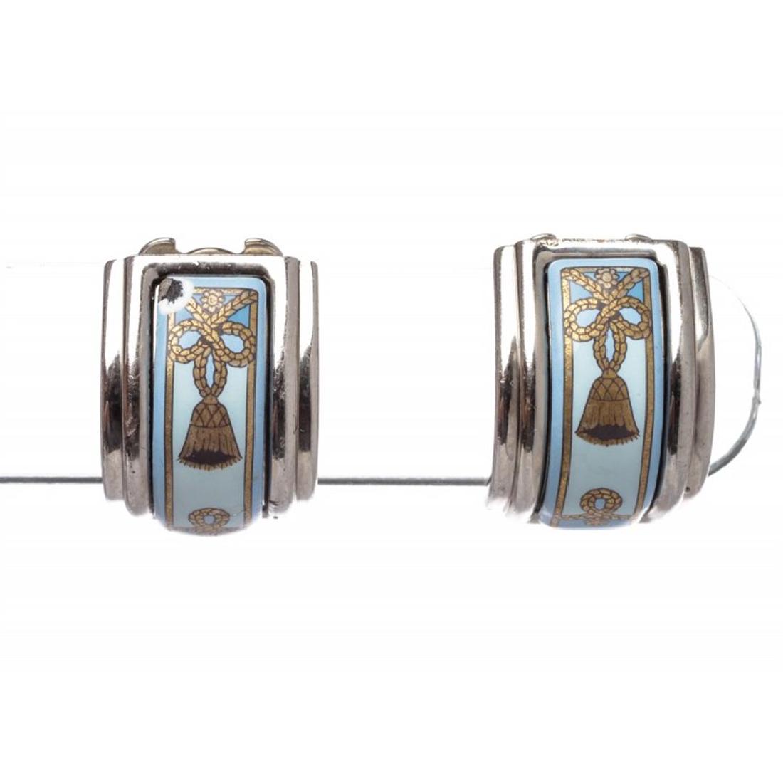 Hermes Palladium Silver Enamel Clip On Earrings: One pair of Hermes Palladium Silver Enamel Clip On Earrings. Crafted out of silver palladium and clip on backing.