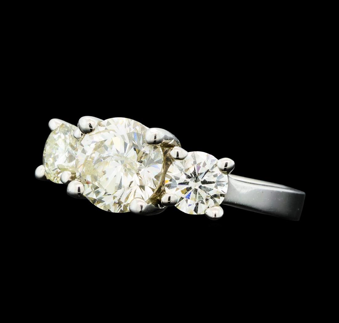 2.37 ctw Diamond Ring - 14KT White Gold: One electronically tested 14KT white gold lady's cast three stone wedding ring with a straight line motif with a bright polish finish. The featured lady's ring has a shank measuring 1.82 millimeters w