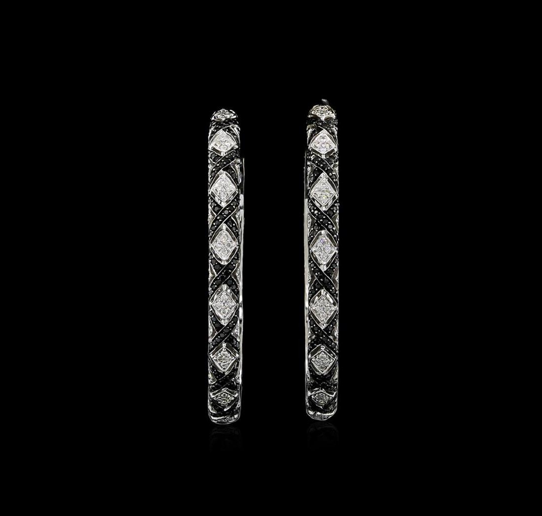 1.48 ctw Black and White Diamond Earrings - 18KT White: One pair electronically tested 18KT white gold ladies cast black and white diamond hoop earrings with screw backs. Each one and three-quarter inch in diameter hoop earring features a white diamond cur