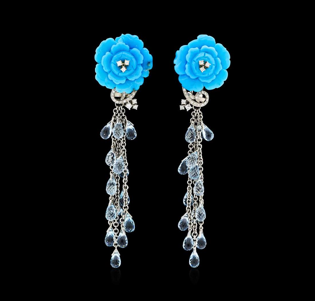 14.00 ctw Blue Topaz, Turquoise and Diamond Earrings -: One pair of lady's earrings with omega backs with posts featuring: 18KT white gold weighing 23.2 grams containing diamonds weighing approximately 0.50ctw, two carved rose-shape turquoise and twenty-ei
