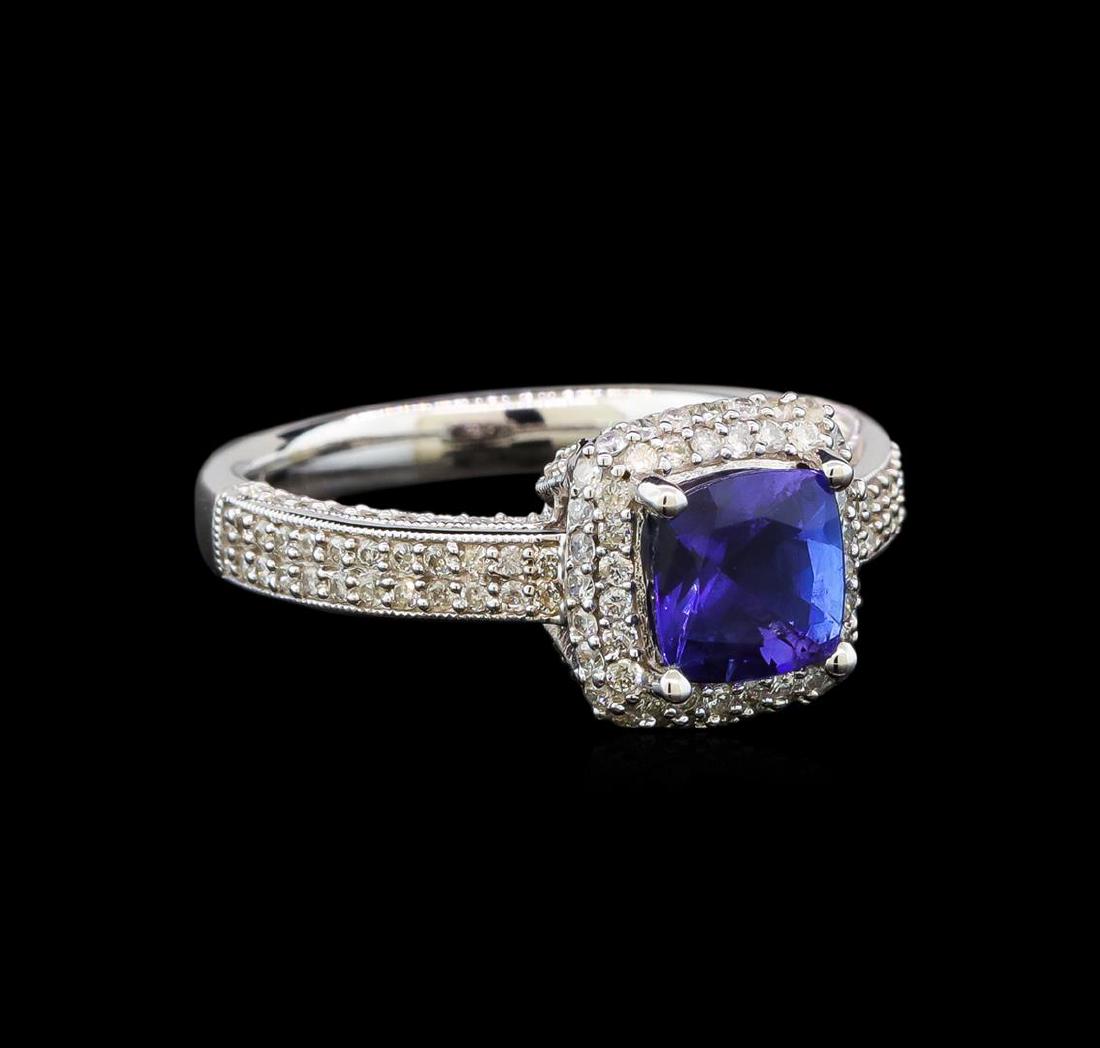 14KT White Gold 1.41 ctw Tanzanite and Diamond Ring: One electronically tested 14KT white gold ladies cast tanzanite and diamond ring with a bright polish finish. Identified with markings of "14K". Condition is new. Containing: One prong set square cush