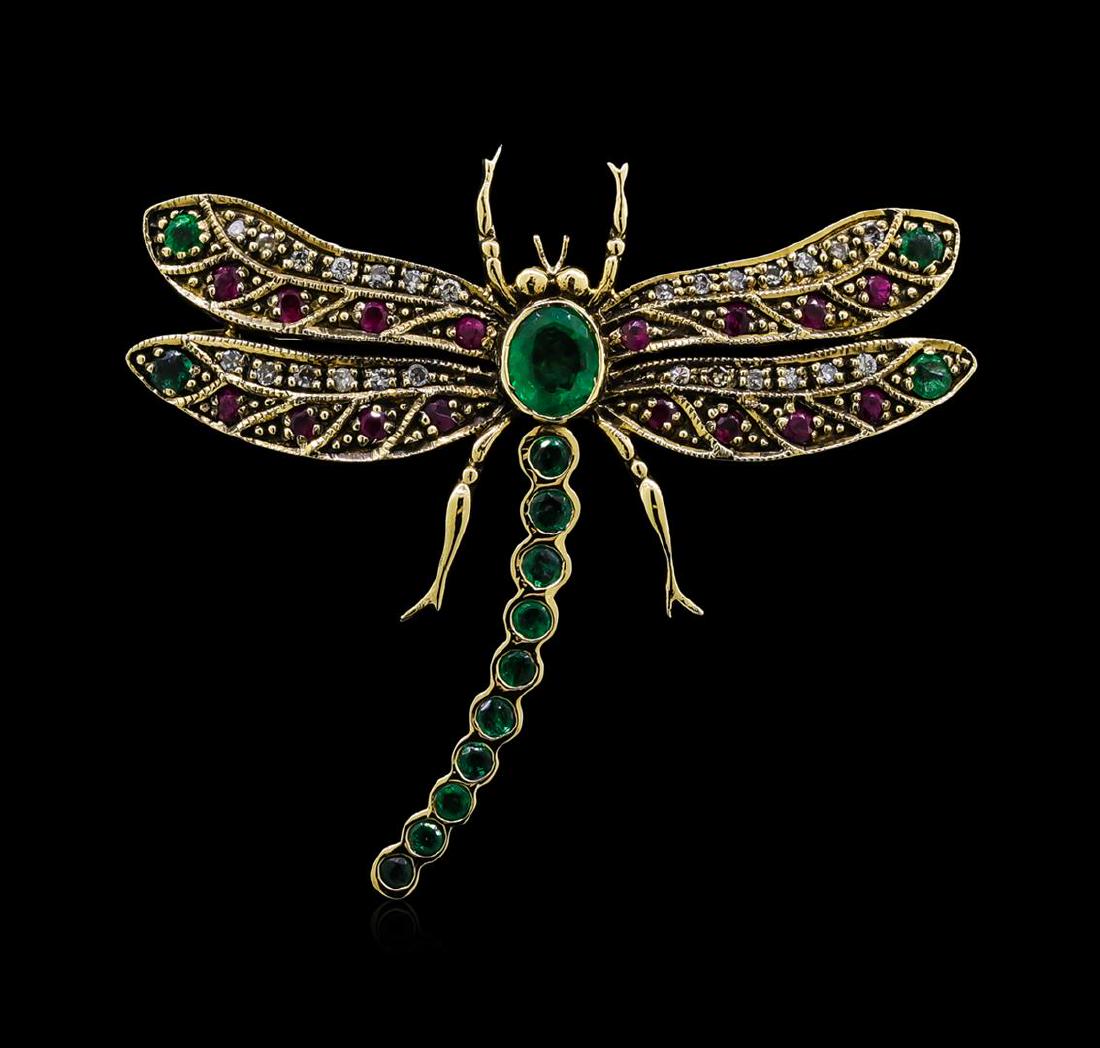 0.72 ctw Emerald, Ruby and Diamond Butterfly Brooch -: One dragonfly brooch featuring: 18KT yellow gold weighing 5.00 grams containing emeralds with a total weight of 0.72ct, rubies with a total weight of 0.25ct, and diamonds with a total weight of 0.15ct