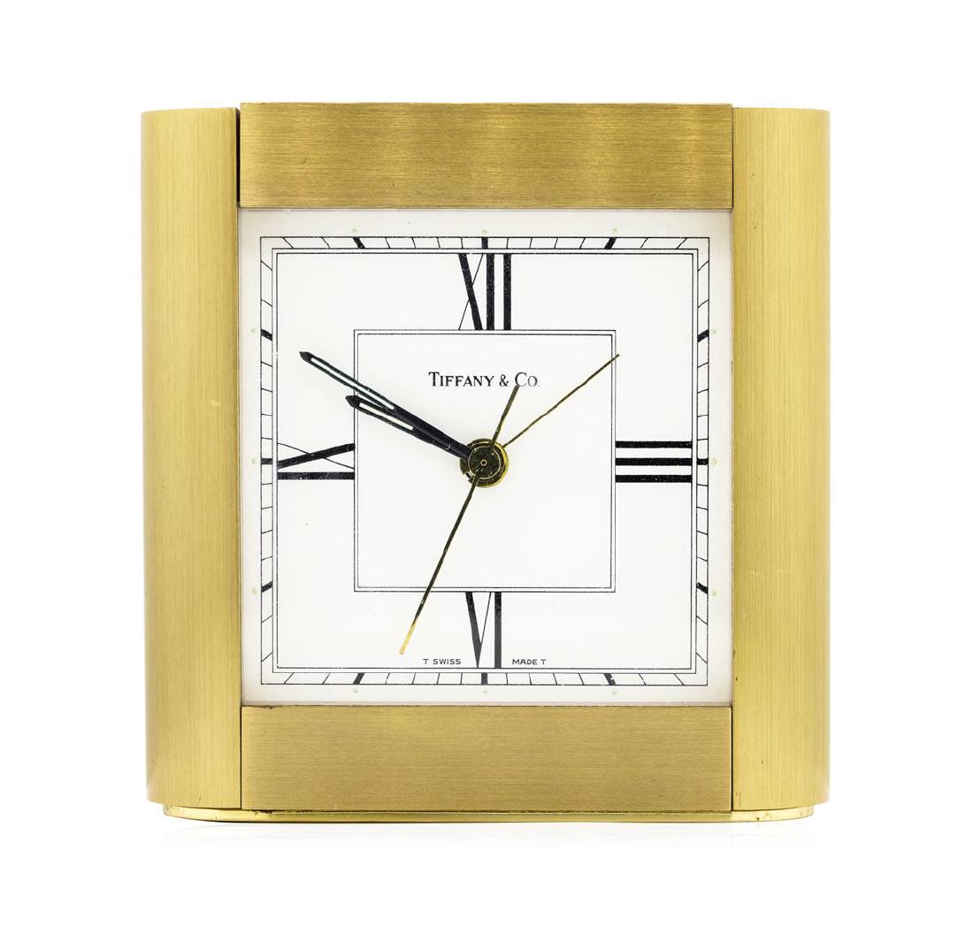 Tiffany & Company Swiss-Made Brass Desk Clock: One Tiffany and Company Swiss-made brass desk clock. The clock measures approximately four inches tall and four inches wide.