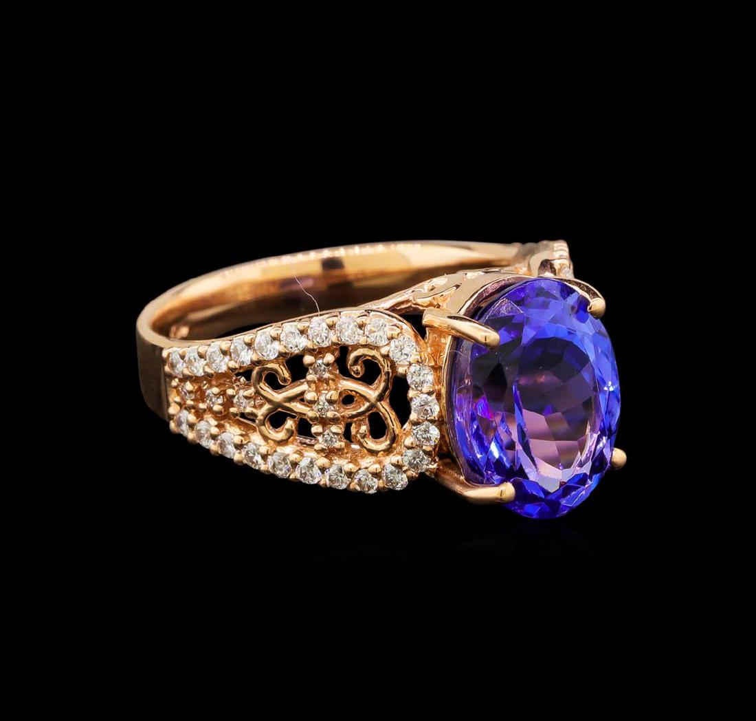 14KT Rose Gold 3.82 ctw Tanzanite and Diamond Ring: One electronically tested 14KT rose gold ladies cast tanzanite and diamond ring with a bright and brushed finish. Identified with markings of "14K". Condition is new. Containing: One prong set oval mo