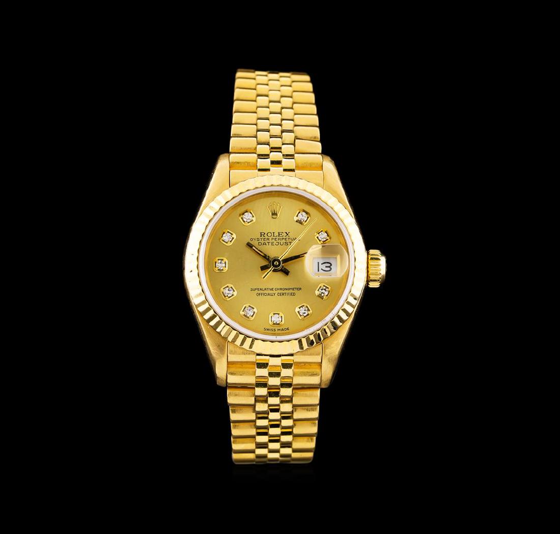 Rolex 18KT Yellow Gold DateJust Ladies Watch: One Rolex DateJust ladies watch featuring: Case: 18KT yellow gold. Bezel: 18KT yellow gold fluted. Crystal: Scratch-resistant sapphire. Dial: Gold color; diamond index hour markers. Features: Date win