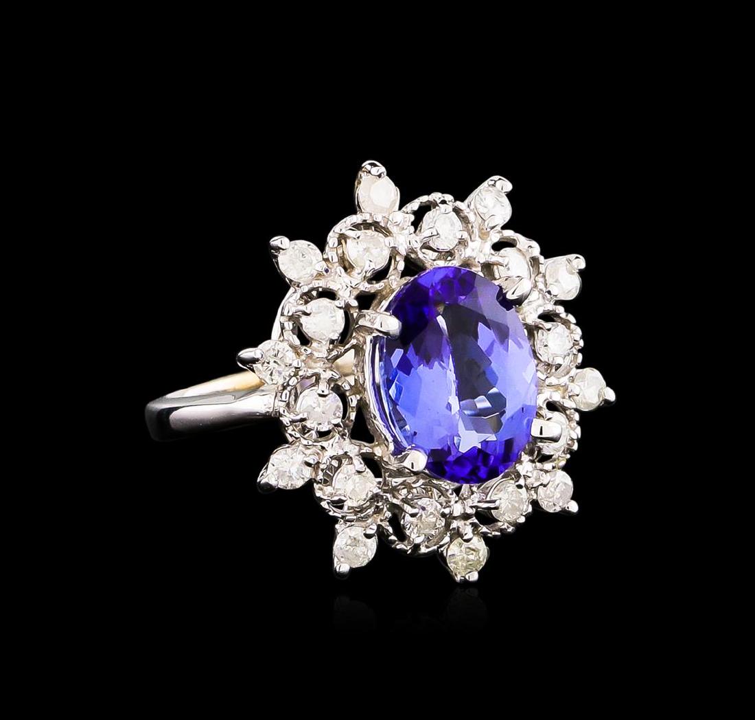 14KT White Gold 3.07 ctw Tanzanite and Diamond Ring: One electronically tested 14KT white gold Ladies cast ring with a bright polish finish. Condition is new. Identified with markings of "14K". Containing: One prong set oval modified brilliant cut natur