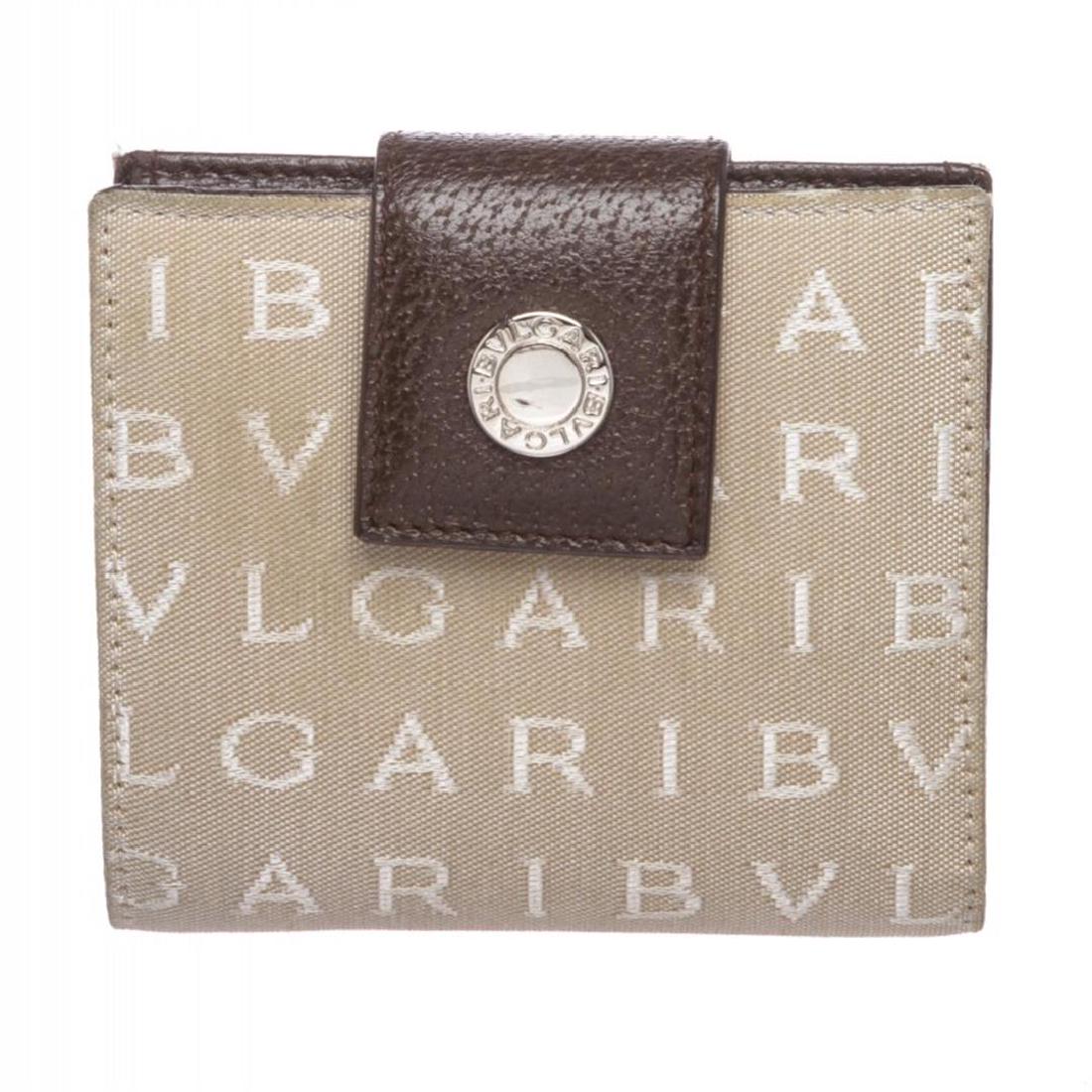 Bvlgari Beige Monogram Fabric Bi Fold Small Wallet: One Bvlgari Beige Monogram Fabric Bi Fold Small Wallet. Crafted out of beige monogram canvas and brown leather trim, snap closure flap. Inner brown leather lining. Three cardots, snap closure pocket, 