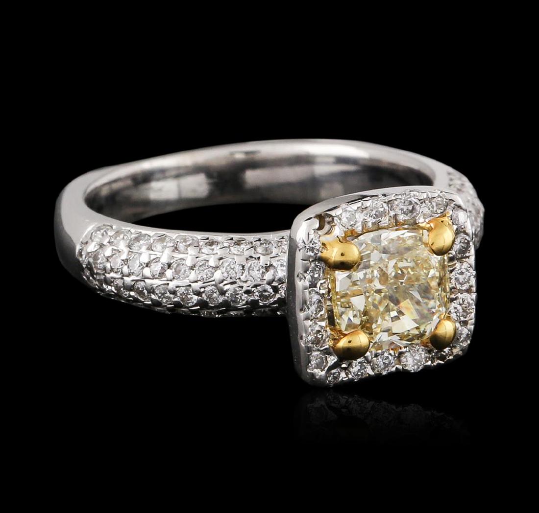 18KT Two-Tone Gold 1.49 ctw Fancy Light Yellow Diamond: One electronically tested 18KT white and yellow gold ladies cast diamond engagement ring with a bright polish finish. Condition is new. Containing: One prong set cushion cut diamond, measuring 5.41 x 