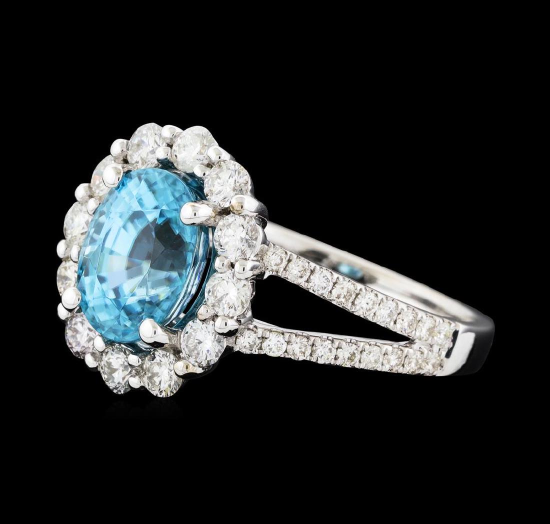 3.56 ctw Zircon and Diamond Ring - 14KT White Gold: One electronically tested 14KT white gold lady's cast fashion ring with a split shank basket halo with a bright polish finish. The featured lady's ring has a shank measuring 2.00 millimeters wide. Ide