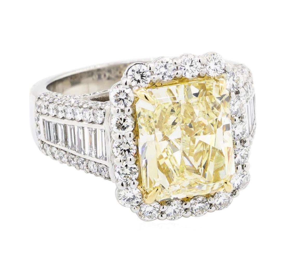 5.02 ctw Center Fancy Yellow Diamond Ring - Platinum: One electronically tested platinum lady's combination cast & assembled wedding ring with a tapered shank with a bright polish finish. The featured lady's ring has an 18KT yellow gold center setting an