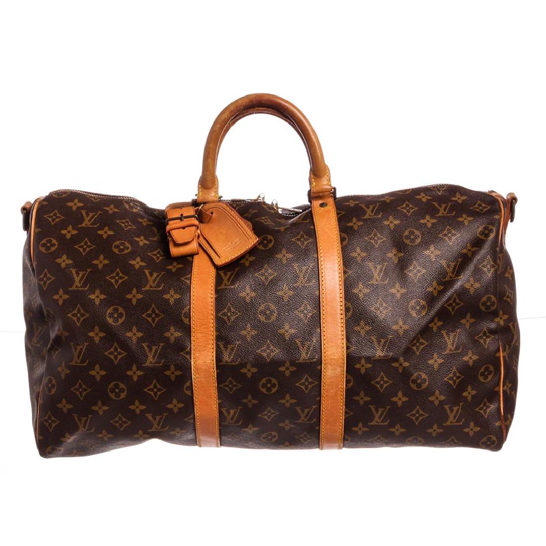 Louis Vuitton Monogram Canvas Leather Keepall 50 cm: Brown and tan Monogram coated canvas Louis Vuitton Keepall BandouliÃ¨re 50 with brass hardware, tan vachetta leather trim, detachable shoulder strap (Not Included), dual rolled top handles, luggage 