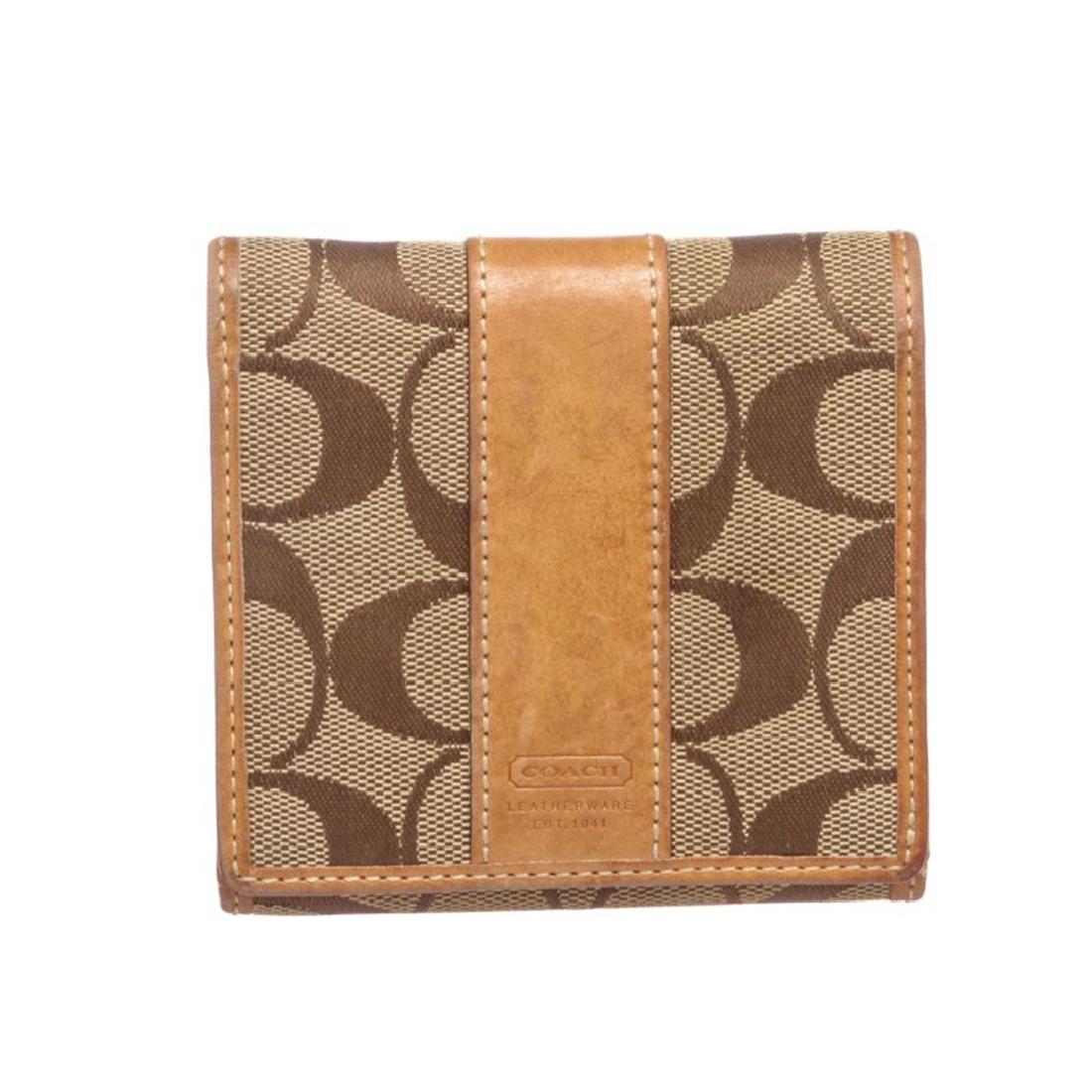 Coach Brown Beige Monogram Canvas Tan Leather Trim: Crafted out of brown beige monogram canvas, tan leather trim, snap closure coin pocket at back, and snap closure front. Inner tan leather lining, six card slots, and dual bill pockets. Item is pre-own