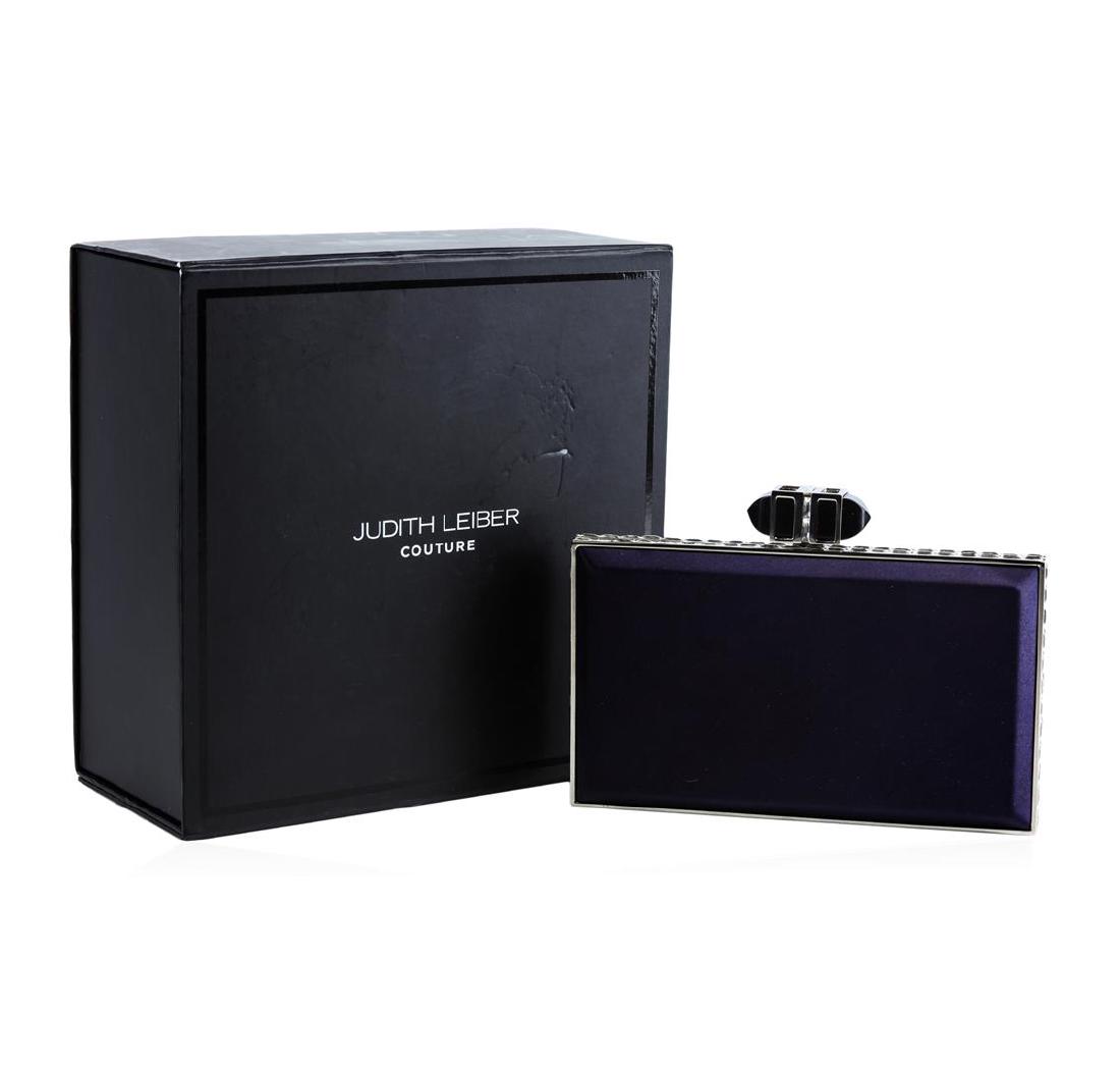 Judith Leiber Couture Satin Coffered Rectangle Clutch: Judith Leiber clutch in satin. Shoulder strap may be tucked in, 8" drop. Framed hard-shell case with crystals. Embellished push-lock clasp at top. Inside, Judith Leiber plaque. Approx. 3.5"H x 6.8"W x