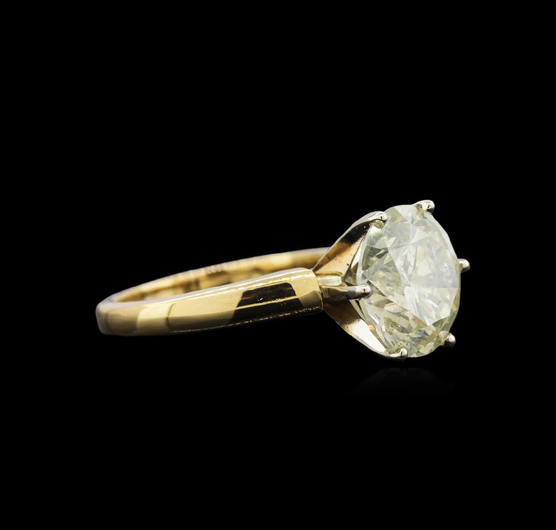 6.27 ctw Light Yellow Diamond Solitaire Ring - 18KT: One electronically tested 18KT yellow gold ladies cast diamond solitaire ring. The featured diamond is set within a white gold basket, completed by a two millimeter wide band. Bright polish finish. Id