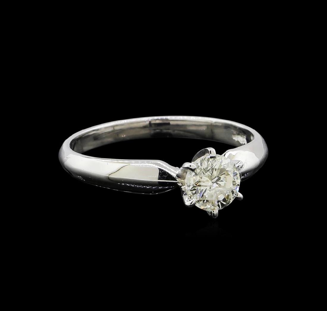 14KT White Gold 0.75 ctw Round Cut Diamond Solitaire: One electronically tested 14KT white gold ladies cast diamond solitaire ring with a knife edge shank with a bright polish finish. Identified with markings of "14K". Condition is new. Containing: One p