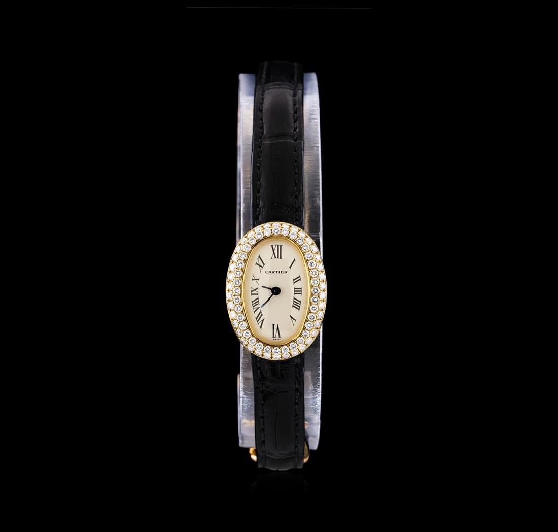 Cartier Baignoir Mini 18KT Yellow Gold Ladies Watch: One Cartier Baignoir Mini lady's watch featuring: Case: Oval 25mm x 18mm 18KT yellow gold. Dial: Silver with pointed baton-type hands and black roman numerals. Bezel: 18KT yellow gold set with diamond