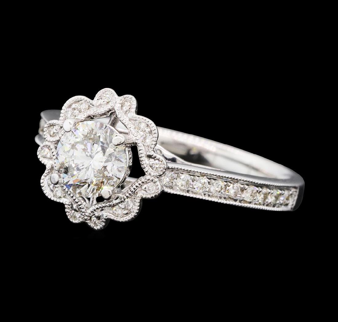 0.87 ctw Diamond Ring - 14KT White Gold: One electronically tested 14KT white gold lady's cast wedding ring with a cathedral shank with a bright polish with milgrain detailing finish. The featured lady's ring has a scalloped halo and a shank