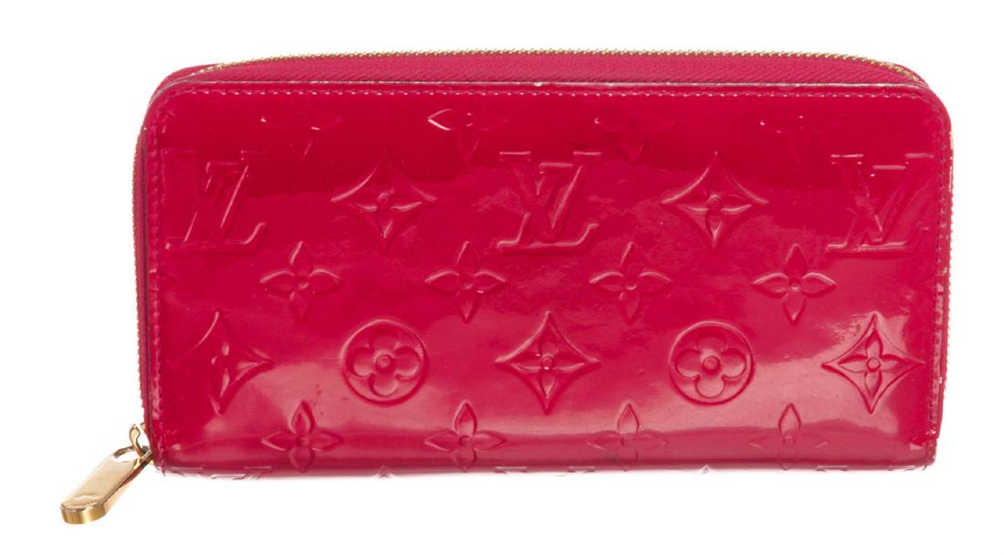Louis Vuitton Framboise Pink Vernis Monogram Zippy: Monogram Vernis leather Louis Vuitton Zippy wallet with brass hardware, tonal leather lining, four interior compartments; one with zip closure, three bill compartments, eight card slots and zip-around